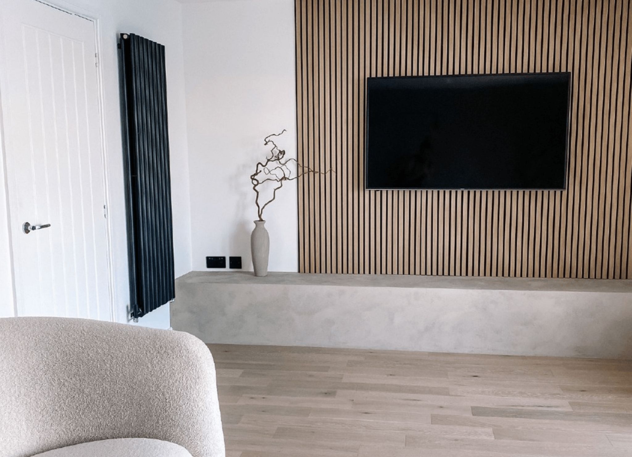 Minimalist, neutral living room with a SlatWall Natural Oak media wall