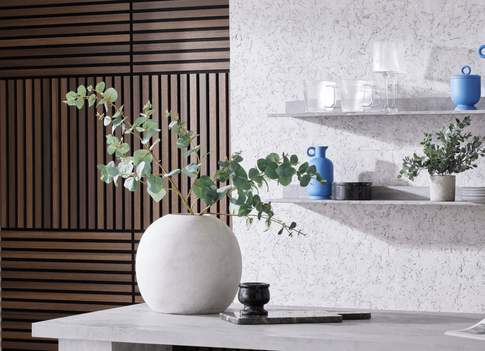 Biophilic interior design featuring shelves with vases of greenery next to SlatWall Mini Smoked Oak and CorkWall Lagos White.