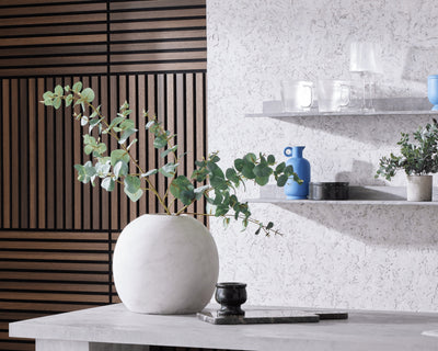 Biophilic interior design featuring shelves with vases of greenery next to SlatWall Mini Smoked Oak and CorkWall Lagos White.