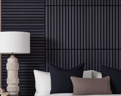 SlatWall Mini Charcoal Black bed headboard next to a white lamp and black and brown cushions