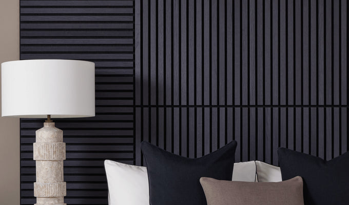 SlatWall Mini Charcoal Black bed headboard next to a white lamp and black and brown cushions