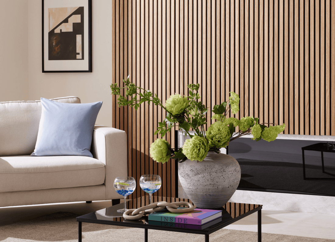 Summer décor idea featuring SlatWall Oiled Natural Oak, a white chair with blue cushion and a vase of green flowers.