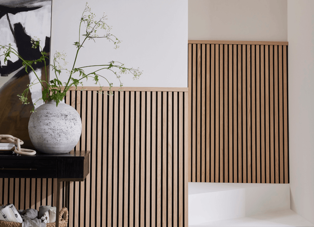 A hallway and staircase featuring half-wall panelling made with SlatWall Midi and a Top Trim in Natural Oak.