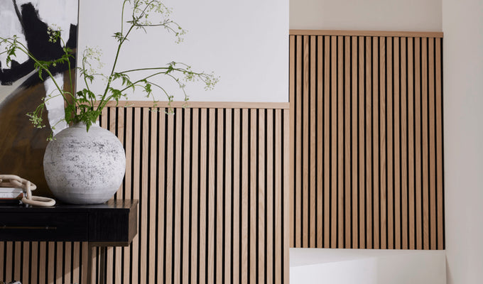 A hallway and staircase featuring half-wall panelling made with SlatWall Midi and a Top Trim in Natural Oak.