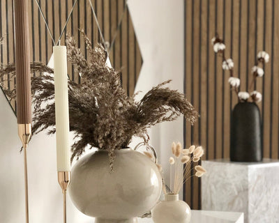 SlatWall panels behind decorative vases and tall candles.