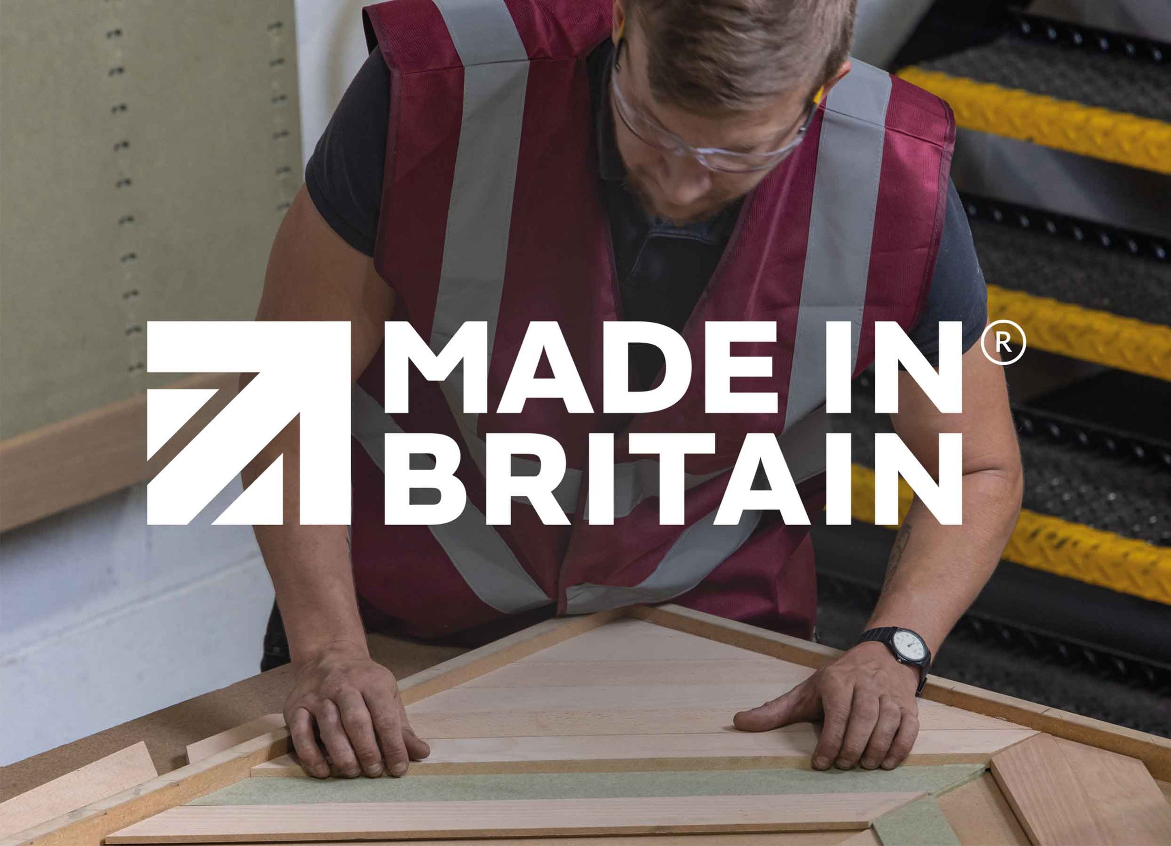 Made in Britain. A craftsperson in Naturewall’s UK factory making a chevron wood wall panel.