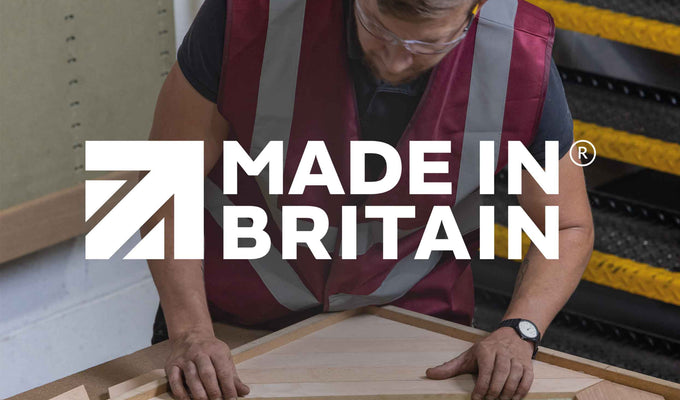 Made in Britain. A craftsperson in Naturewall’s UK factory making a chevron wood wall panel.