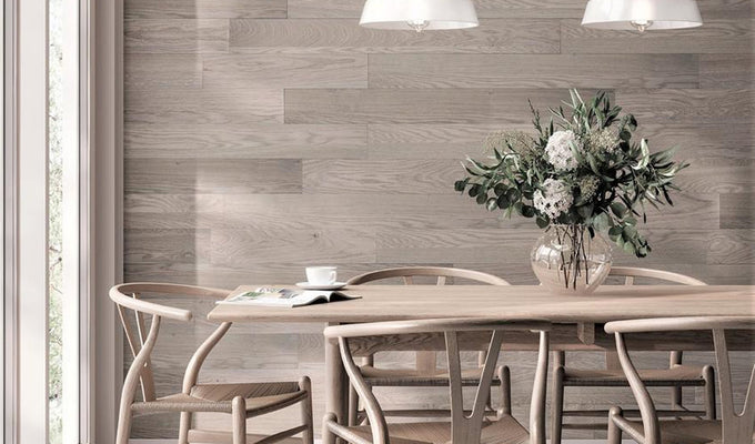 Light coloured wooden table and chairs with Peel & Stick Sky Grey covering the wall behind.