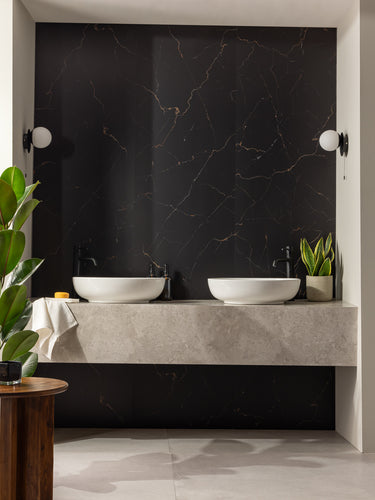 Elemence Shower Panels Marquina Black on wall behind two wash basins and plants in bathroom setting