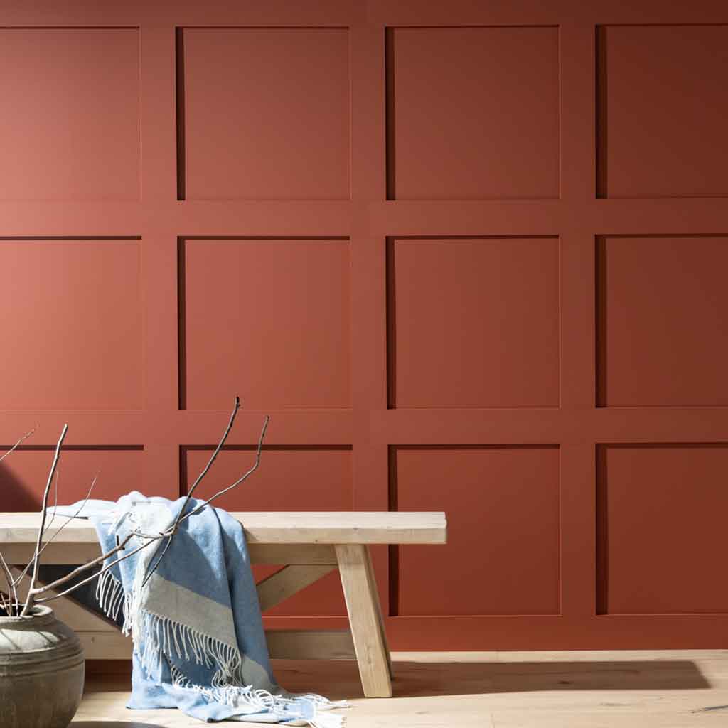 image of a wall panelling kit painted red with a bench in front of it 