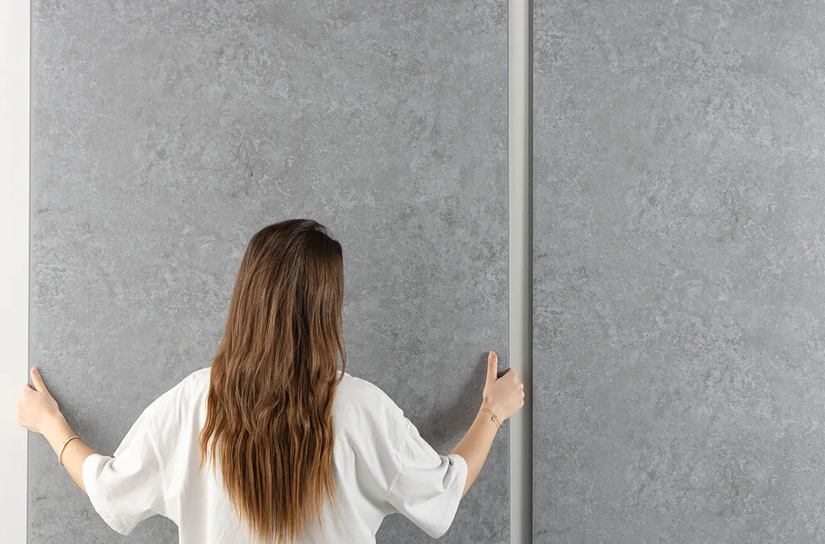 image of person fitting a pvc shower panel 