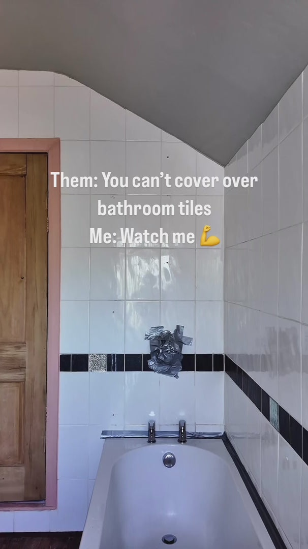 Load video: video of person fitting shower panel over tiles 