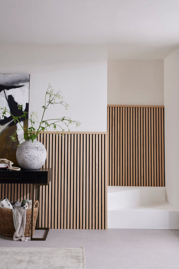SlatWall Midi Natural Oak decorating a half wall in the hall way

