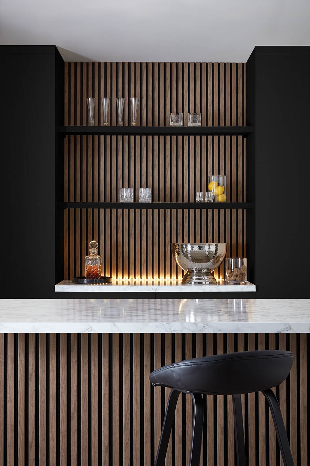 Home Bar setting using SlatWall Waterproof in Walnut and Black colours, creating a modern decor.
