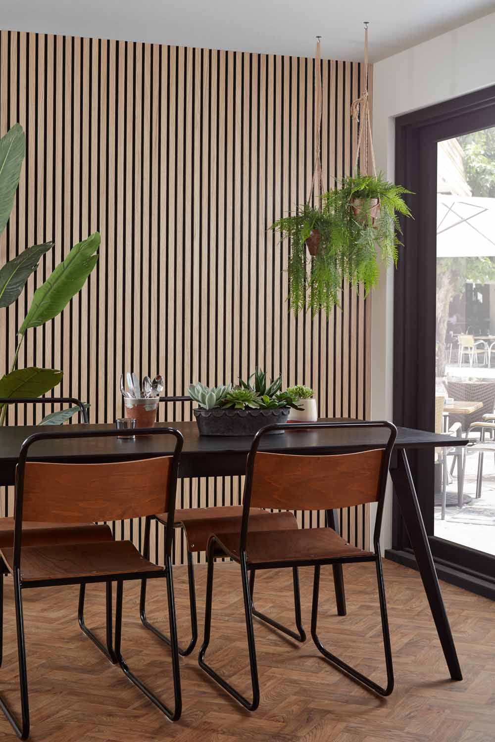 Natural Oak and Black Acoustic SlatWall Panels from Naturewall in a dining room setting. 