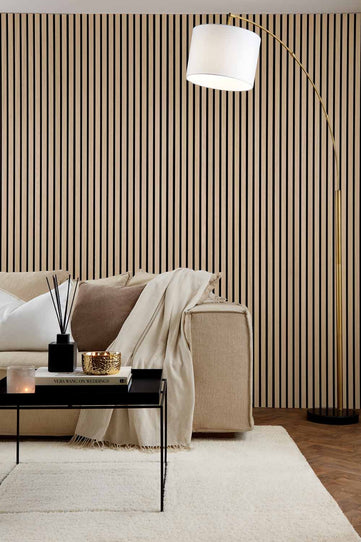 Natural Oak SlatWall Panels installed floor to ceiling in a living room setting, behind a sofa and coffee table.