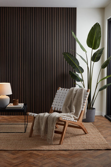 Smoked Oak SlatWall Panels installed in a living room setting, floor to ceiling.

