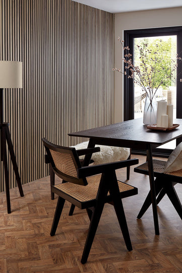 Walnut SlatWall Panels from Naturewall in a dining room setting, installed floor to ceiling.

