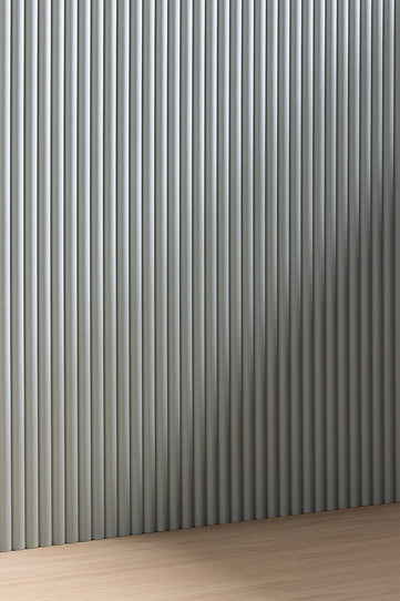 image of an unprimed wooden reeded panel on a wall

