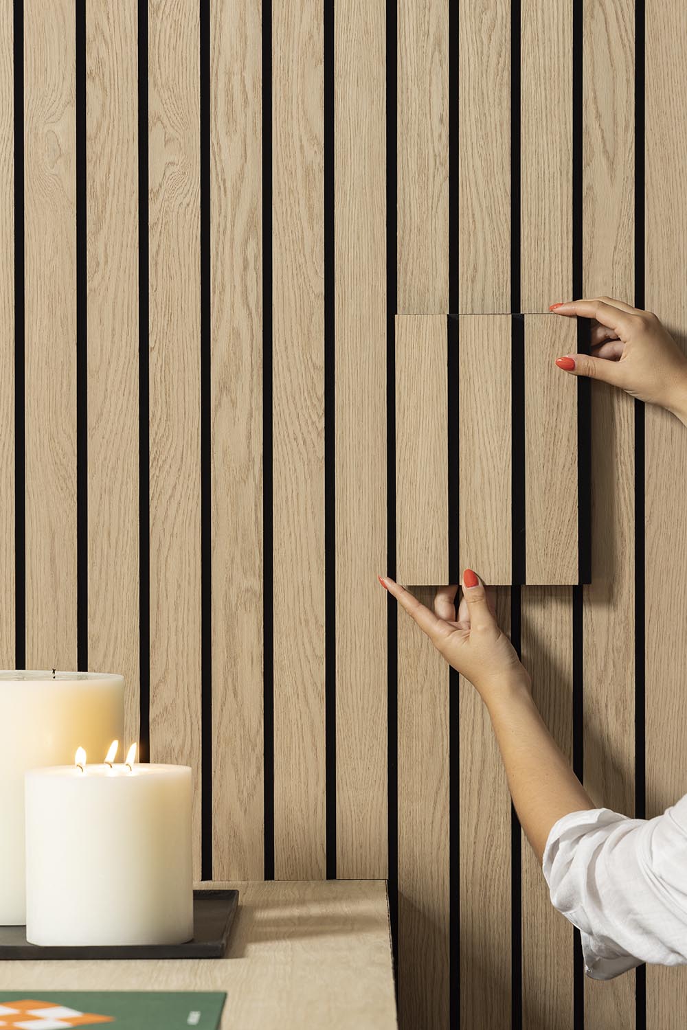 Natural Oak Slatwall Grand sample held in comparison against Natural Oak Slatwall Grand wall.

